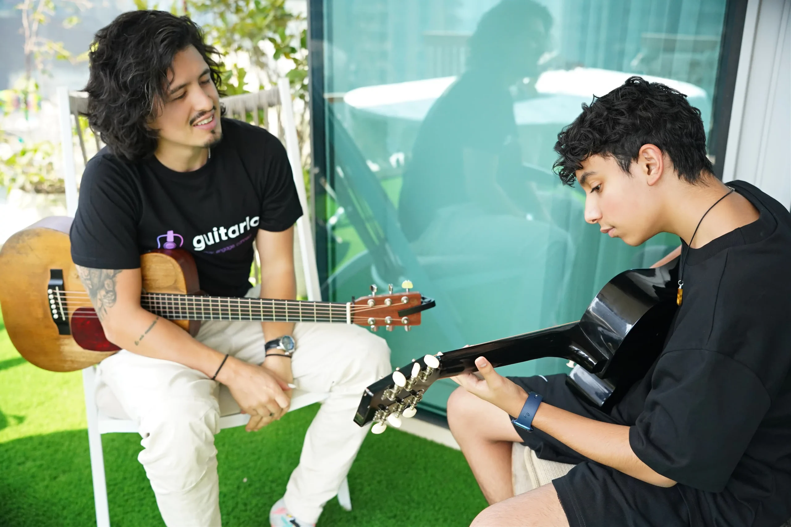 Giancarlo teaching a student guitar